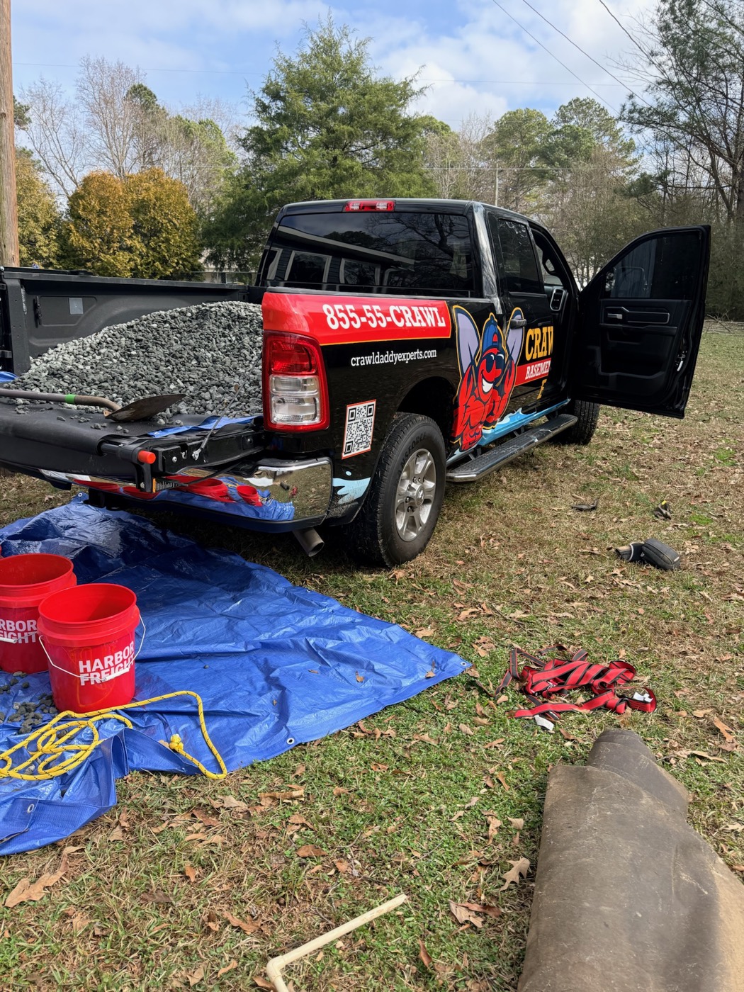The Crawl Daddy branded truck on a Metro Atlanta job site, bed loaded with gravel