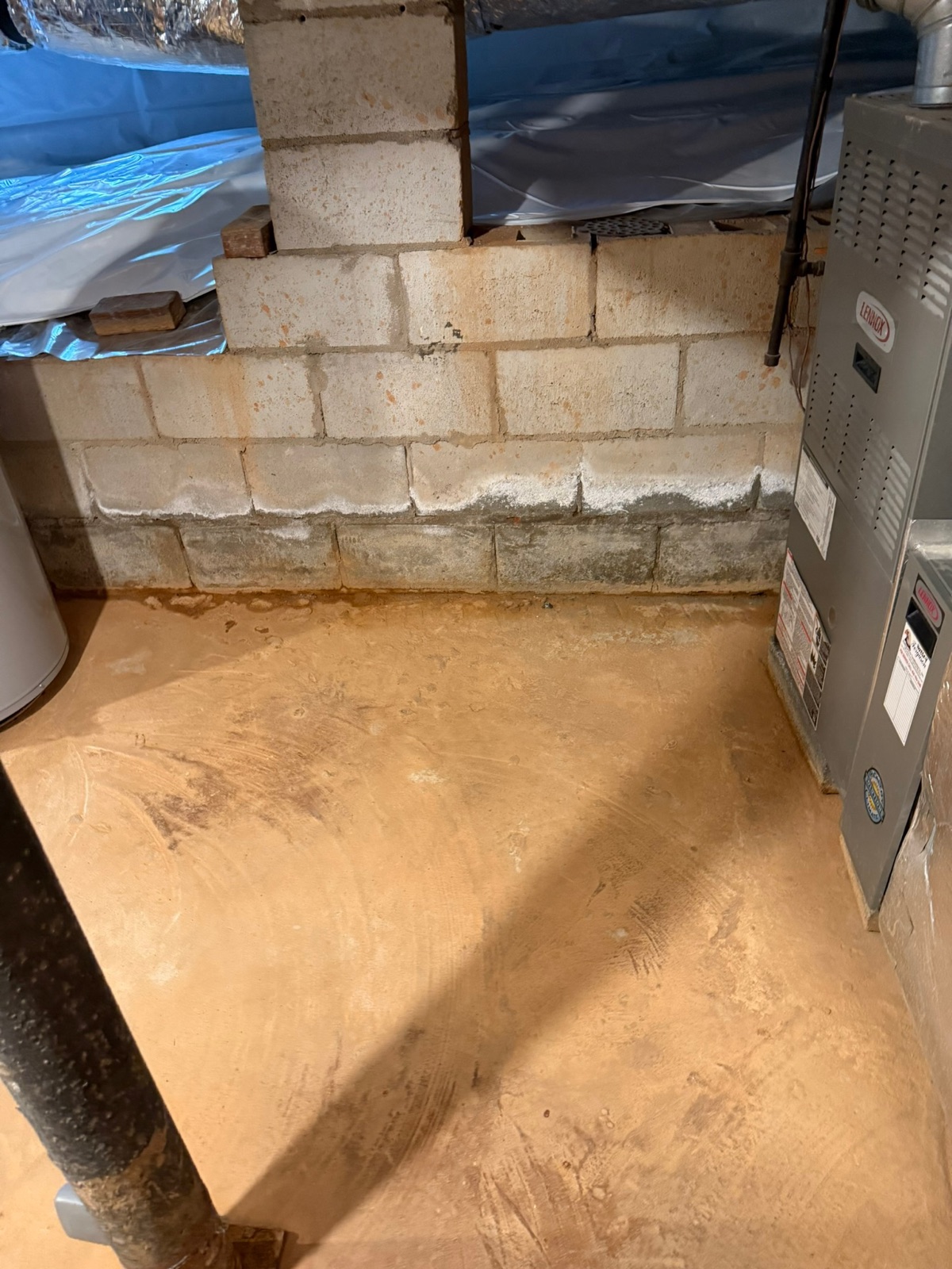 Block wall basement with efflorescence and moisture damage — before waterproofing