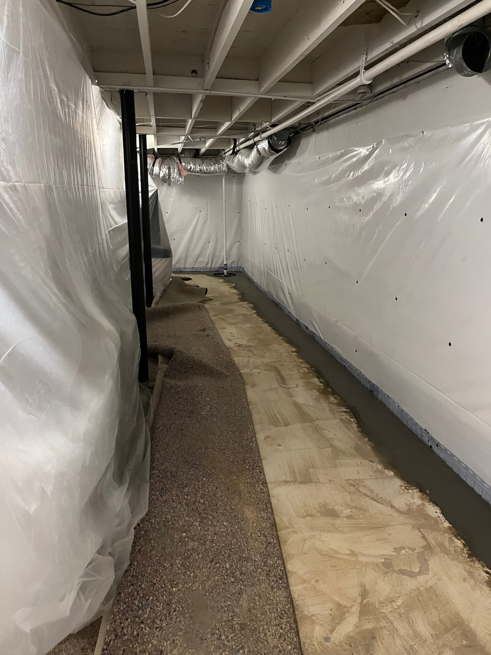 Finished basement waterproofing with perimeter drain, vapor walls, and sump system — Crawl Daddy install, Metro Atlanta