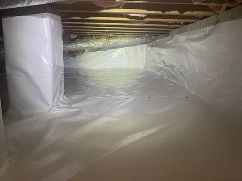 Interior crawl space drain and sump basin moving water out from under a Metro Atlanta home — Crawl Daddy waterproofing