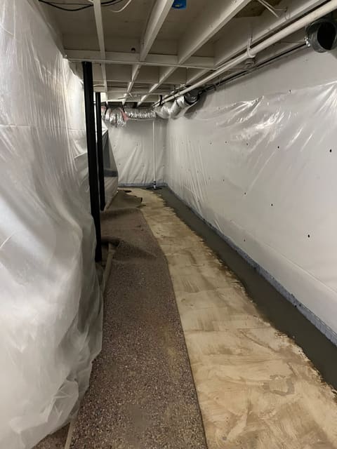 Finished, dry basement with a sealed interior drainage system and sump in a Metro Atlanta home — Crawl Daddy basement waterproofing